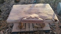 a wooden table with a scary face on it