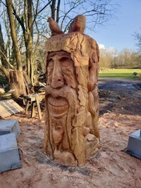 a wooden carving of a man with a beard