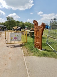 a wooden gate at the entrance to a playground