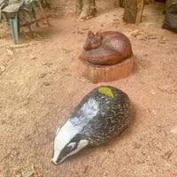 a wooden sculpture of a badger and a fox