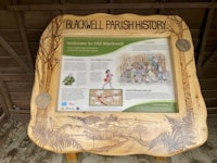 a wooden sign that says buckwell parish history