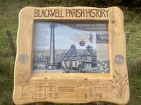 a wooden sign with a picture of the blackwell irish history