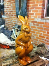 a statue of a rabbit sitting on a pallet