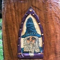 a wooden carving of a wizard with a hat on it