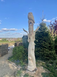 a statue of an owl in a garden