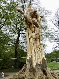 a tree trunk with a carving of a woman and a child