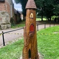 a wooden statue of a castle in a park