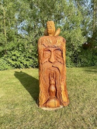 a wooden sculpture of a man with a beard