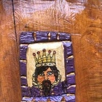 a wooden plaque with a picture of a king on it