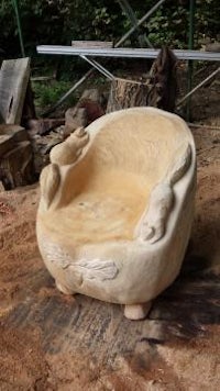 a wooden chair is being made in a wooded area