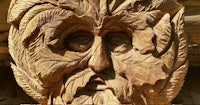 a wood carving of a green man