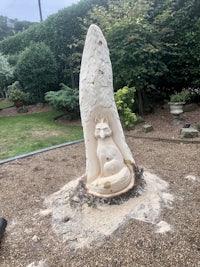 a tree stump with a carving of a fox