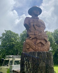 a statue of a soldier on top of a tree stump