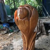 a wooden sculpture with a flower on it