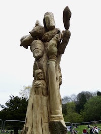 a sculpture of a tree with people on it