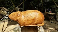 a wooden sculpture of a guinea pig