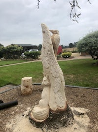 a carving of a bird on a tree stump