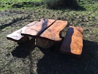 a wooden picnic table in a field