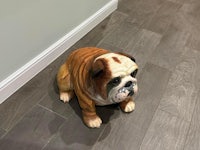 a statue of a bulldog sitting on the floor