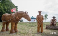 two wooden statues of a man and a horse