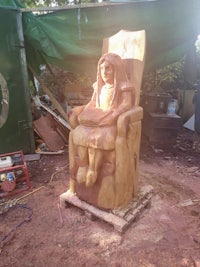 a statue of an egyptian woman sitting in a chair