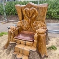 a wooden throne made out of a tree stump