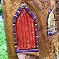 a tree trunk with a door and window