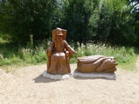 a wooden statue of a king and a king's throne