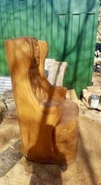 a wooden chair is being made in a yard