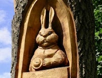 a carving of a rabbit in a tree