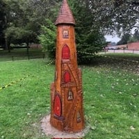 a wooden statue of a castle in a park