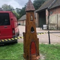 a gingerbread house in front of a barn