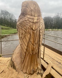 an owl is carved out of a tree stump