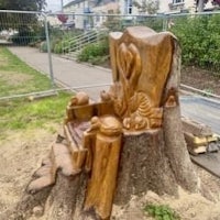 a tree stump has been carved into a chair